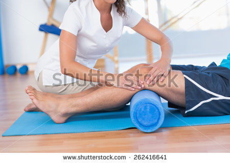 stock-photo-trainer-working-with-man-on-exercise-mat-in-fitness